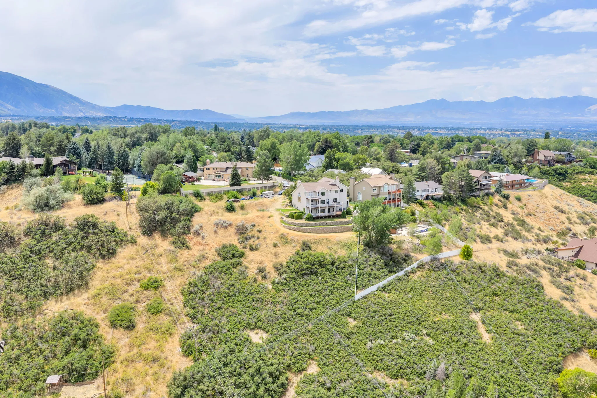 Elevated property featuring tiered landscaping and mountain scenery