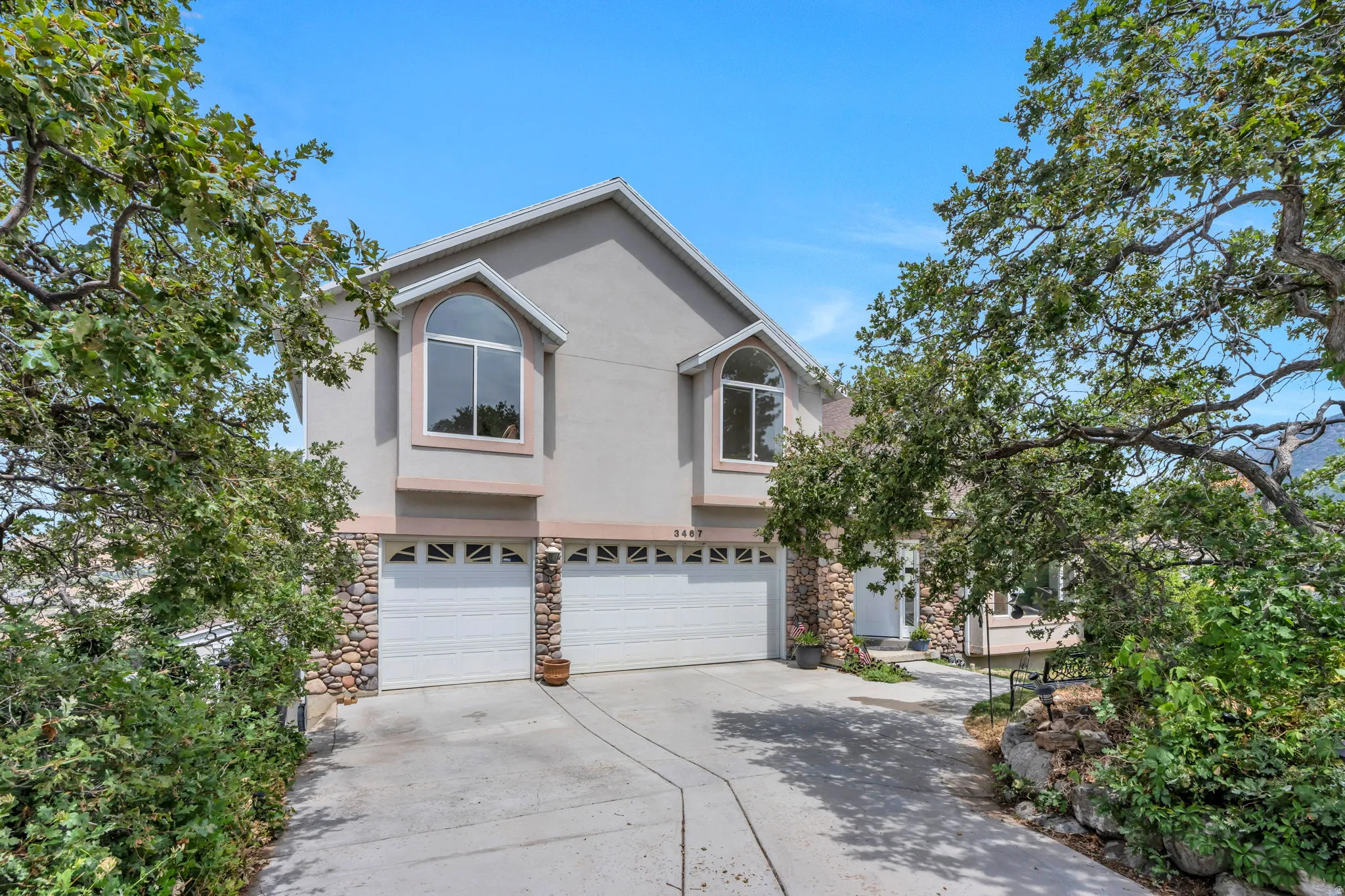 Stucco exterior with stone accents and arched window features