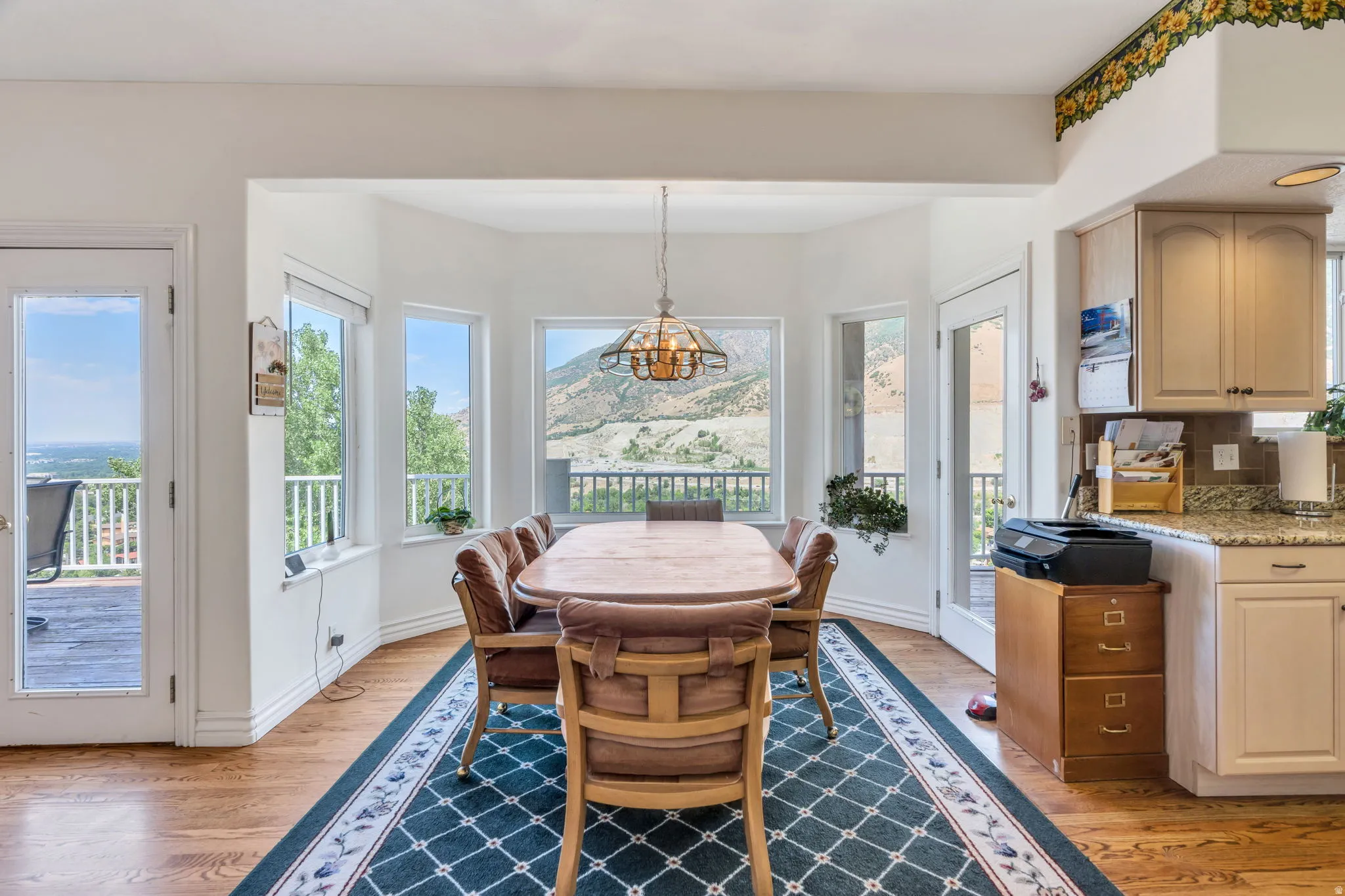 Dining area featuring wood-finish flooring and a central chandelier