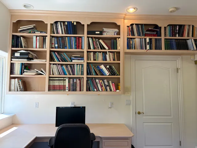 Built-in custom cabinetry, built-in desk, recessed lighting, window, paneled door