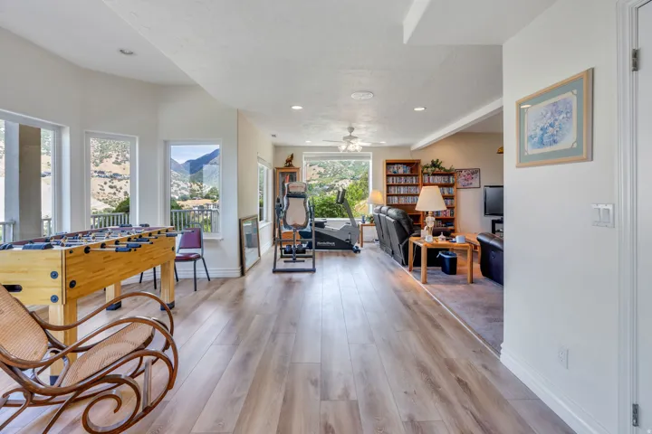 Open-concept room featuring wood-finish flooring, recessed lighting, and multiple windows