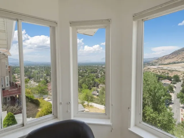 View From the Master Bedroom. Bay window with multiple glass panes and roller shades,