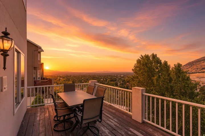 Expansive outdoor deck with wood-finish flooring and white railings