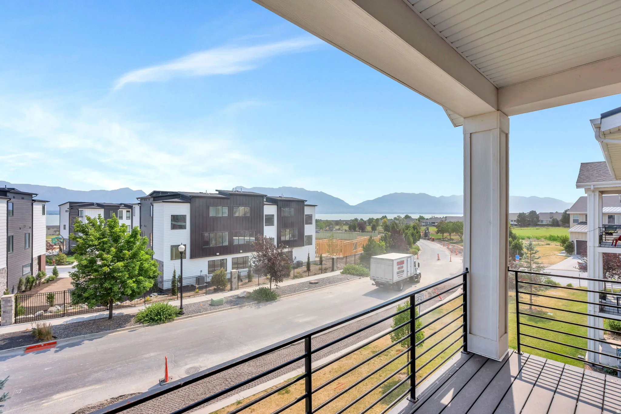 Balcony featuring composite decking and horizontal metal railings