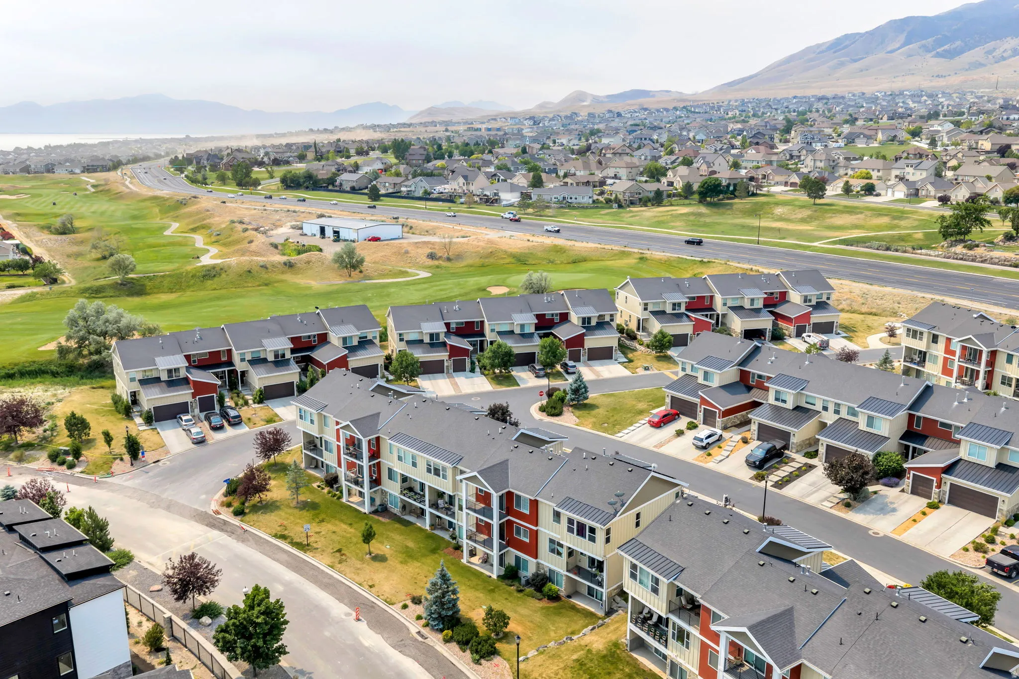 Residential community featuring multi-story townhomes and apartment-style buildings with varied exterior finishes