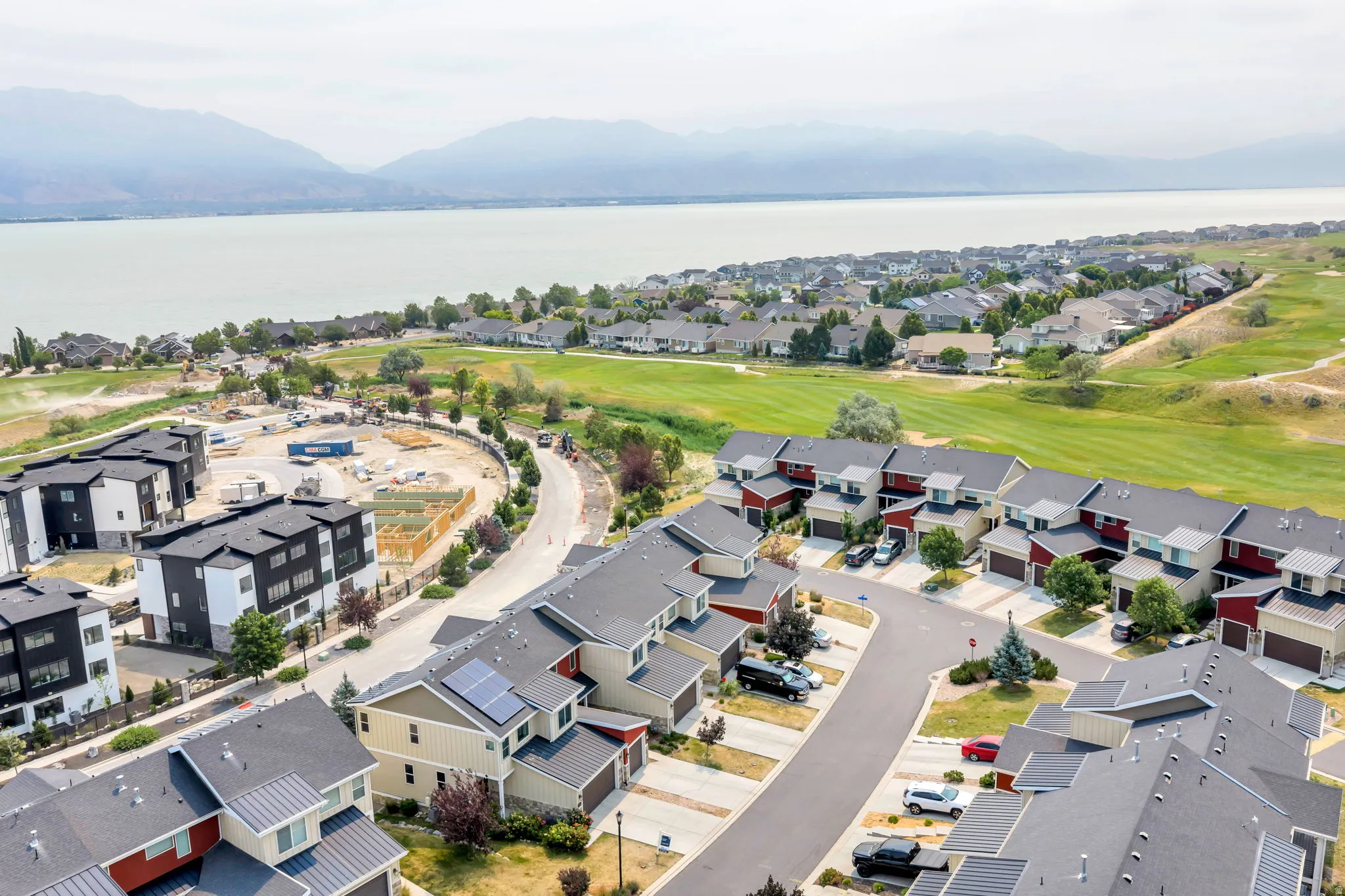 Aerial perspective showcasing a residential community with townhomes and detached properties