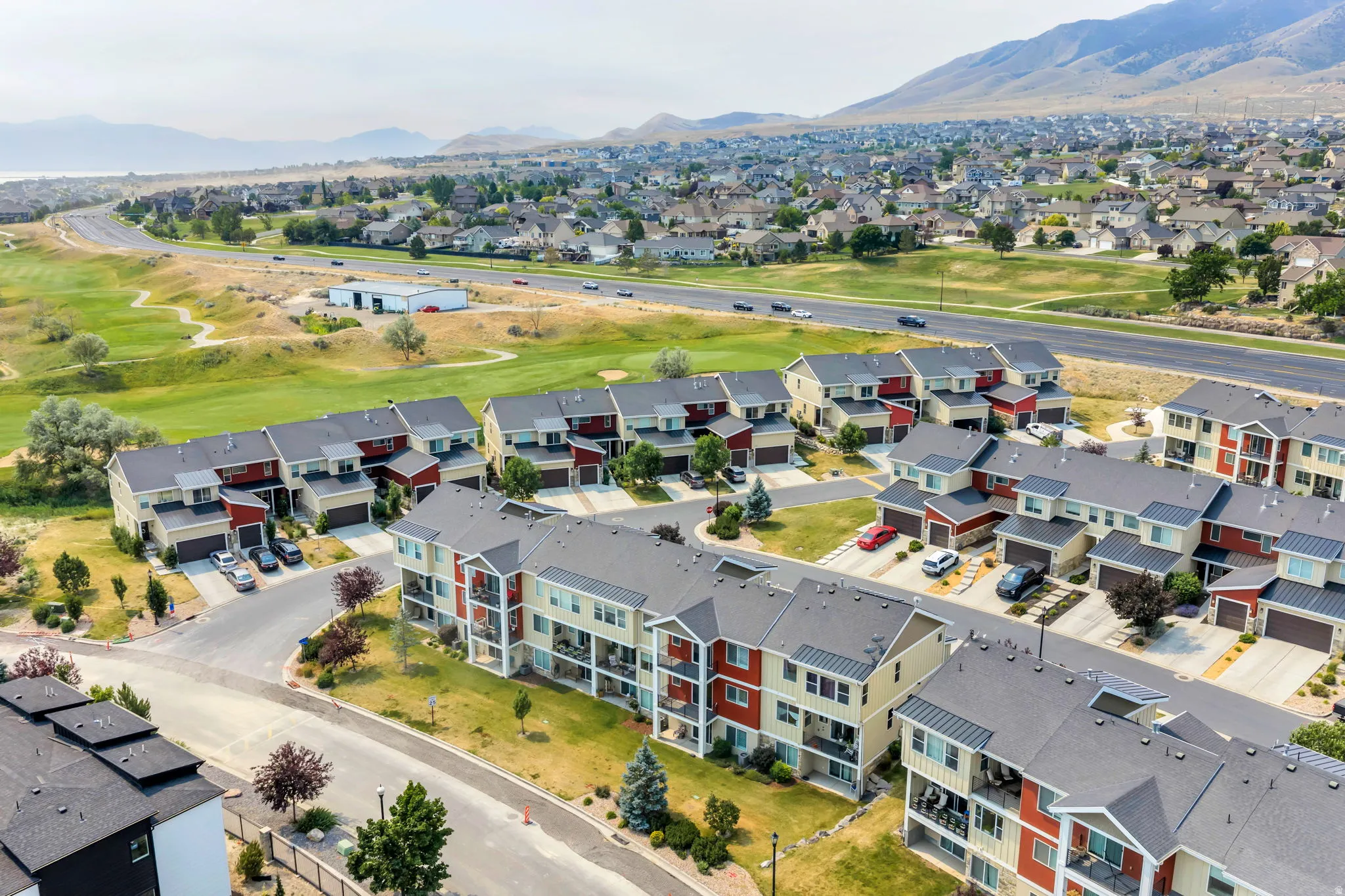 Modern residential community featuring multi-story units with balconies and attached garages