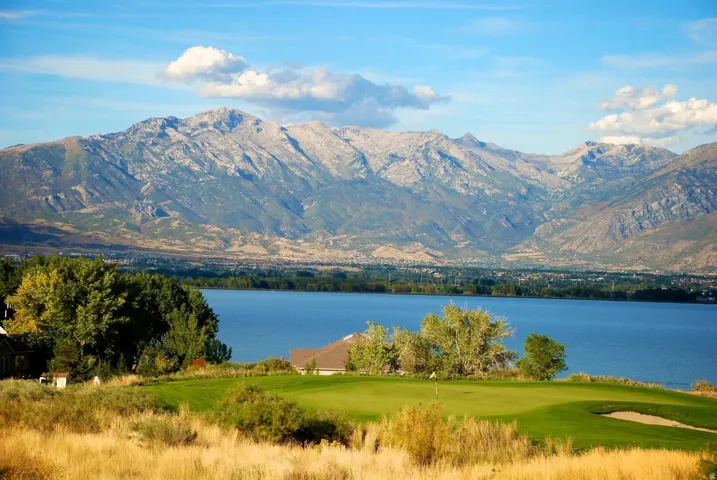 Golf course setting featuring a manicured green and sand trap
