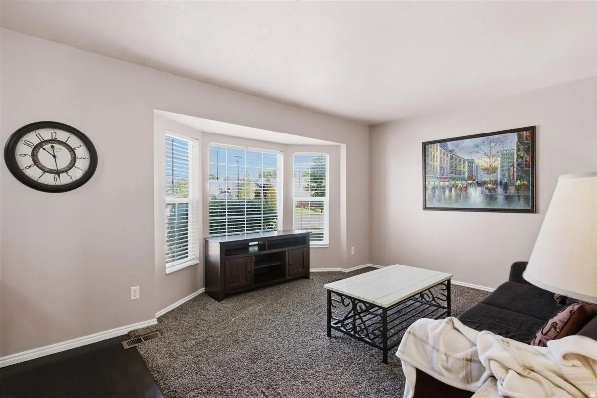 Bay window with white blinds and dark wood-finish trim