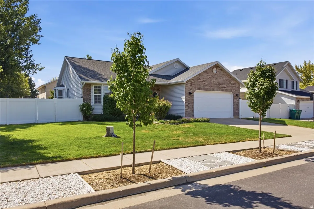 Single-story residence featuring a brick facade and an attached two-car garage