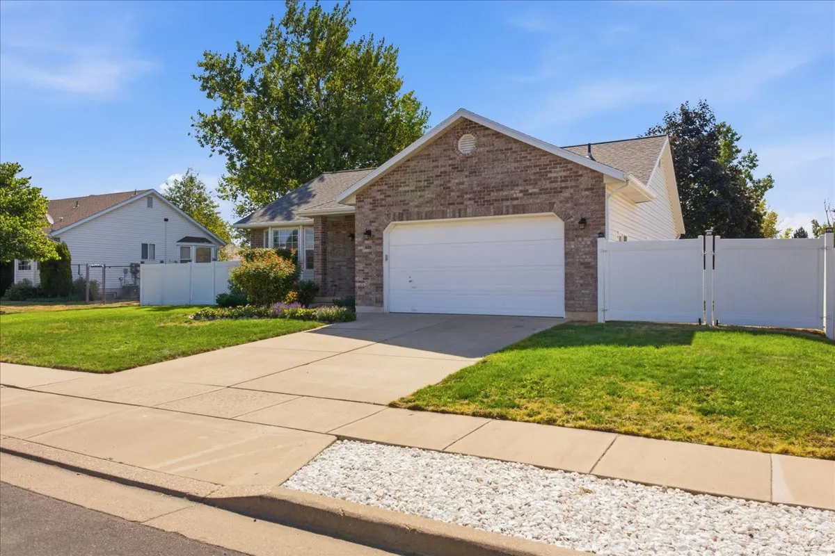 Brick and siding exterior featuring an attached two-car garage