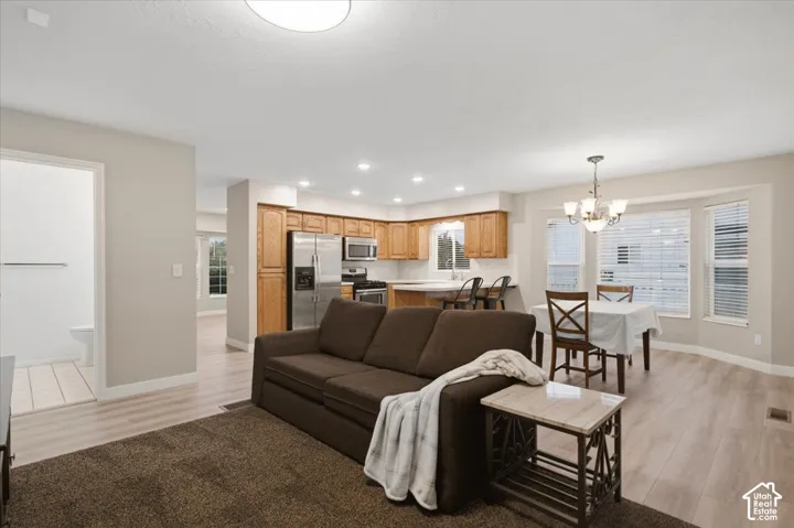 Kitchen featuring wood cabinetry, stainless steel appliances, recessed lighting, and a bay window