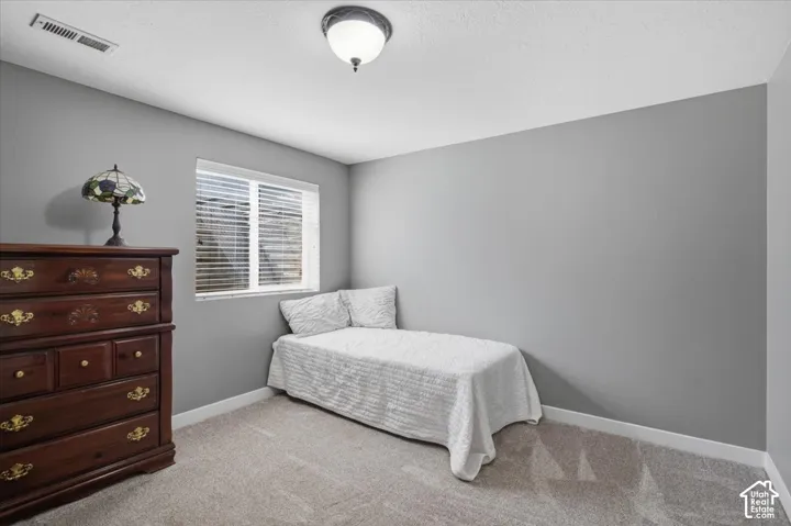 Room featuring light gray walls, white trim, and light-colored carpeting