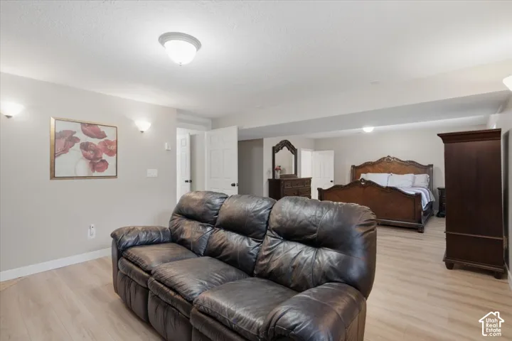 Massive Primary Basement Master room sitting room. Open concept room with light wood-finish flooring