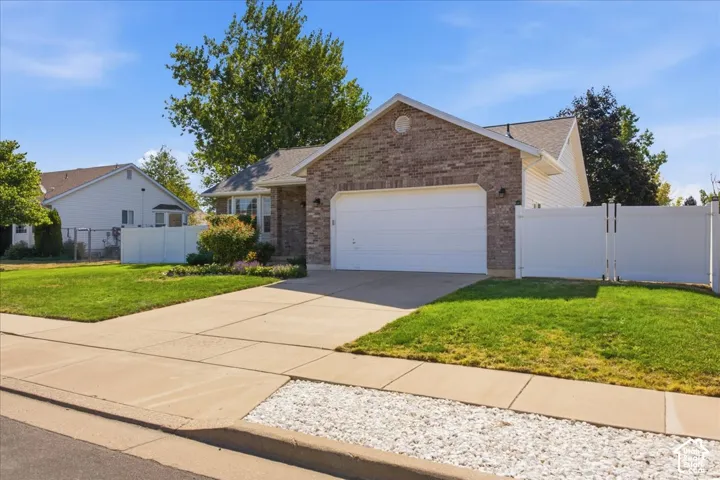 Brick and siding exterior featuring an attached two-car garage
