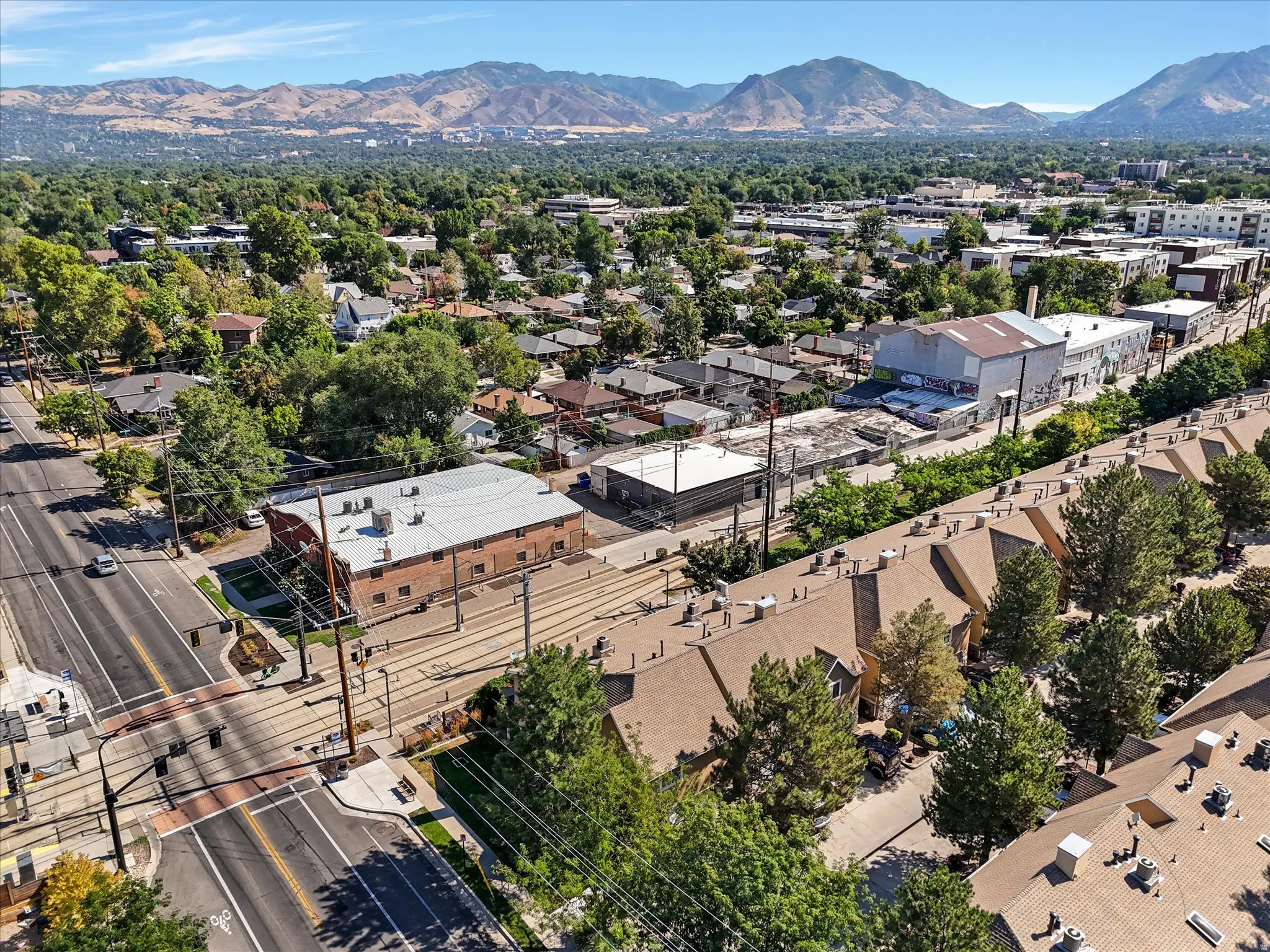 Urban landscape featuring multi-lane roadways, commercial structures, and residential properties