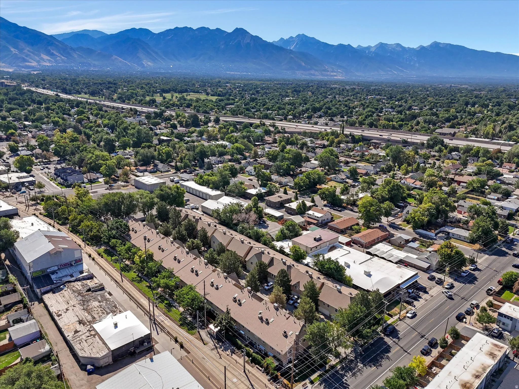 Expansive aerial view showcasing a dense residential area with mature tree coverage