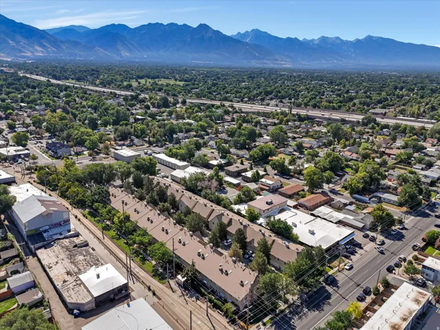 Expansive aerial view showcasing a dense residential area with mature tree coverage