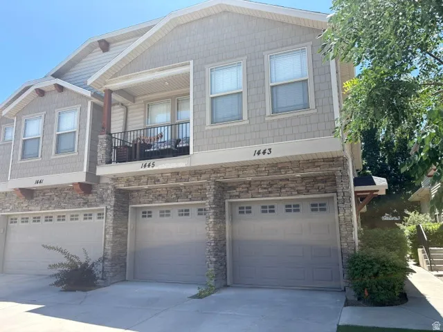 Multi-level property featuring a stone and siding exterior