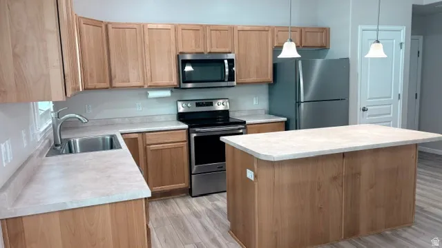 Kitchen featuring light wood cabinetry and light-toned countertops