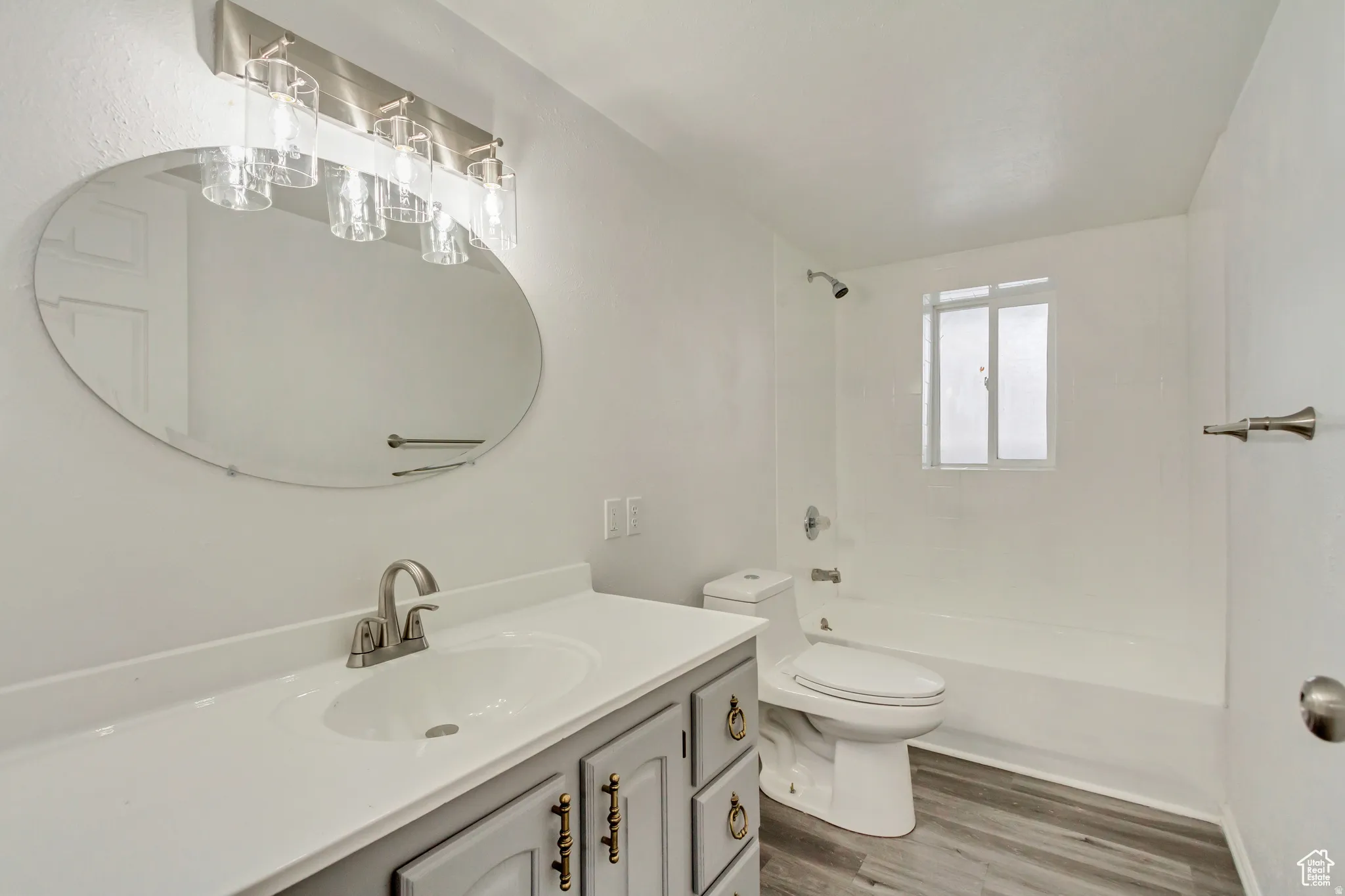 Bathroom featuring a vanity with a light gray cabinet, white countertop, and brushed nickel hardware