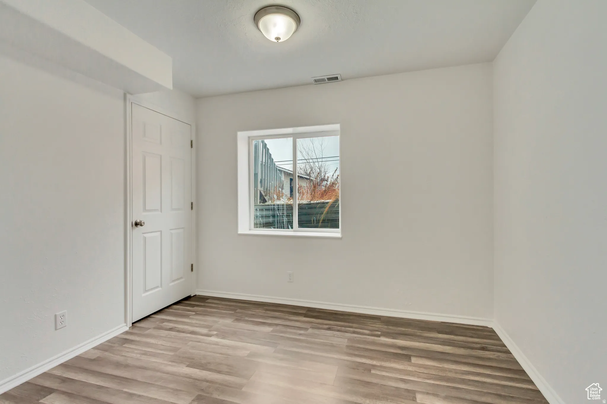 Neutral wall finishes complement the wood-finish flooring