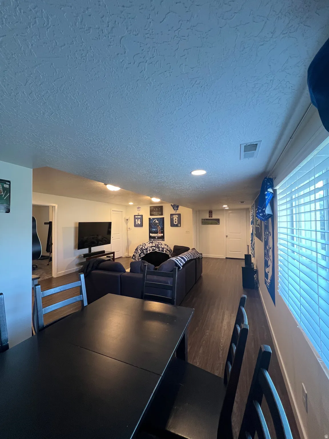Recessed lighting throughout, wood-finish flooring, and white window blinds