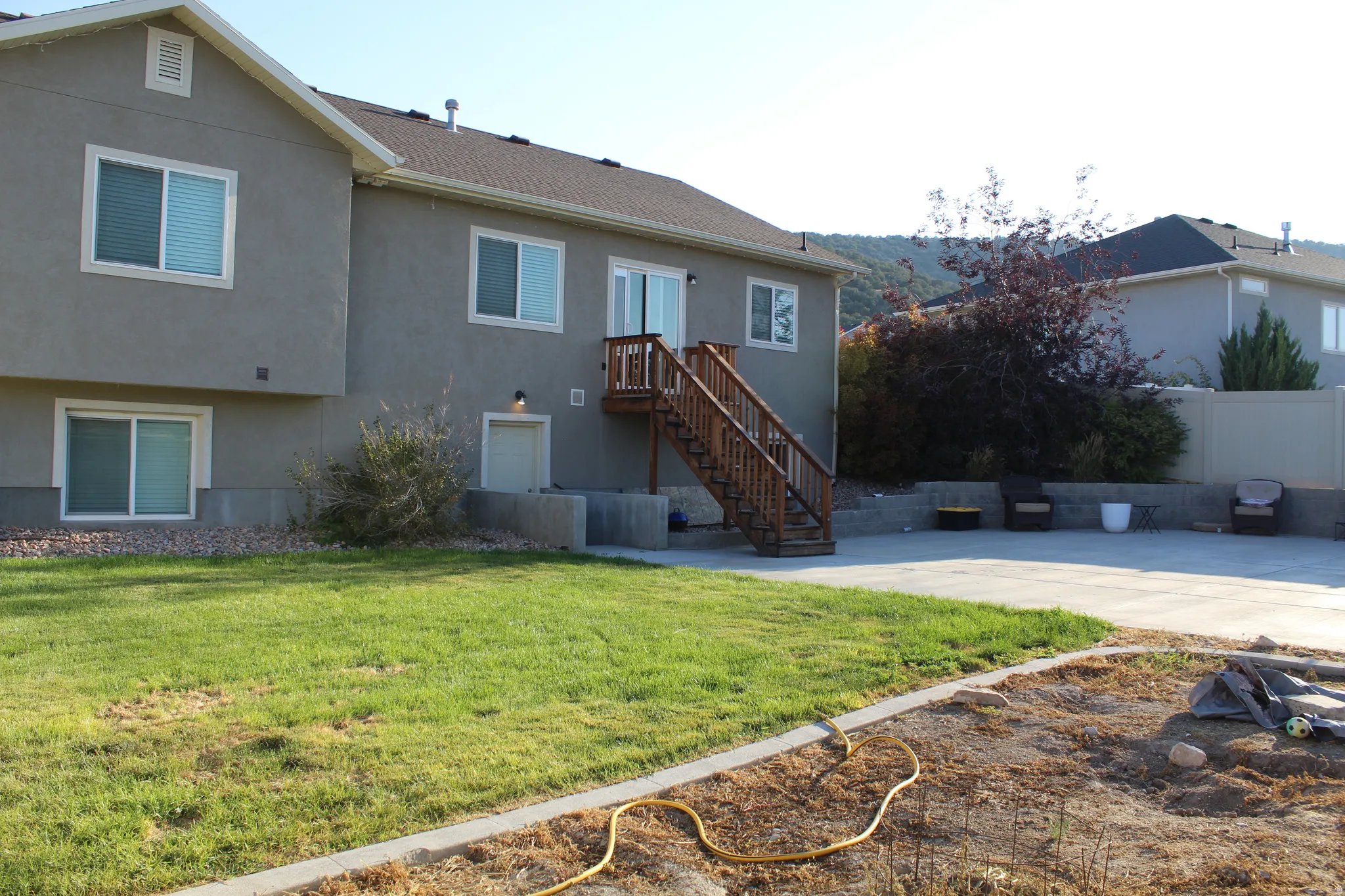 Stucco exterior with multiple windows and a wooden exterior staircase