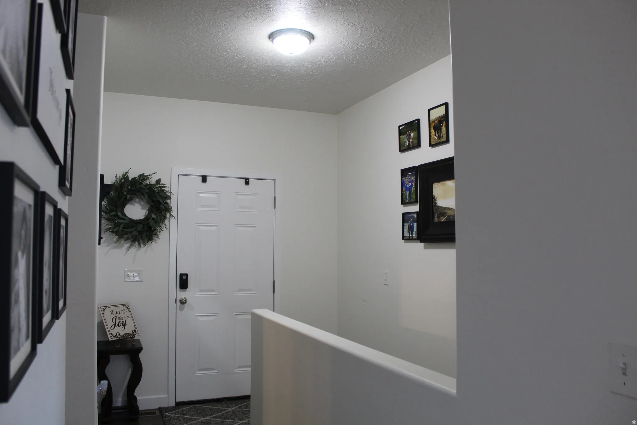 Single panel interior door with a smart lock, complemented by a semi-flush mount ceiling light