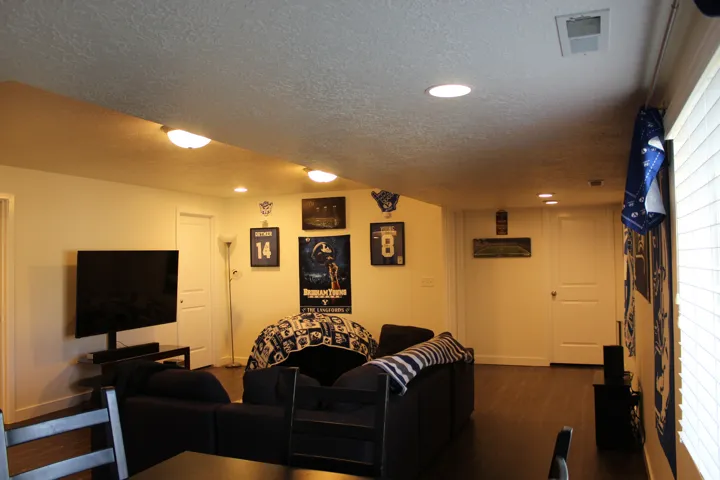 Recessed and semi-flush ceiling lighting, white interior doors, and wood-finish flooring