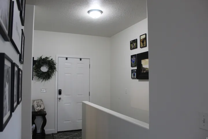 Single panel interior door with a smart lock, complemented by a semi-flush mount ceiling light