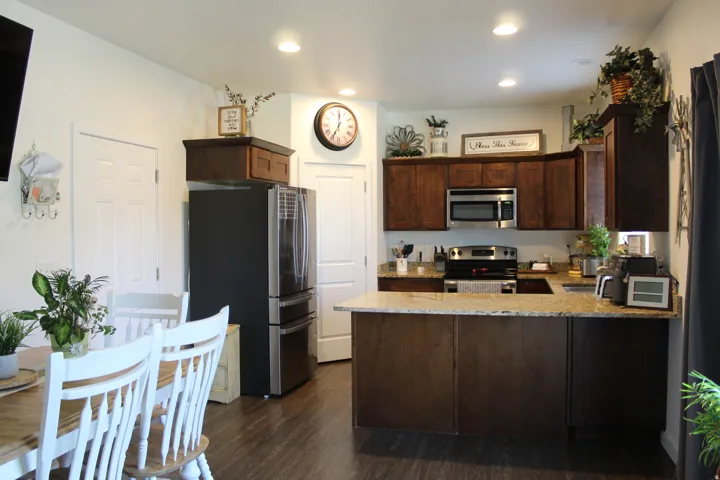 Kitchen featuring rich wood cabinetry, stainless steel appliances, and light-toned countertops