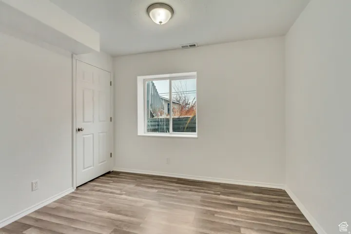Neutral wall finishes complement the wood-finish flooring
