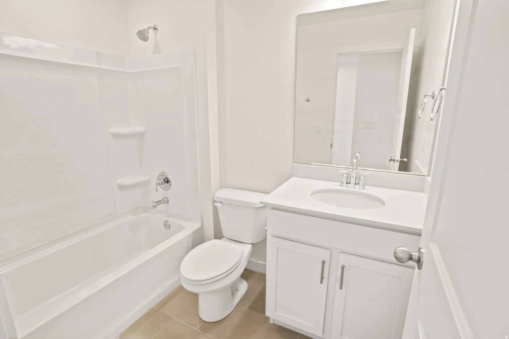Bathroom featuring a white vanity with an integrated sink, polished chrome faucet, and coordinating hardware