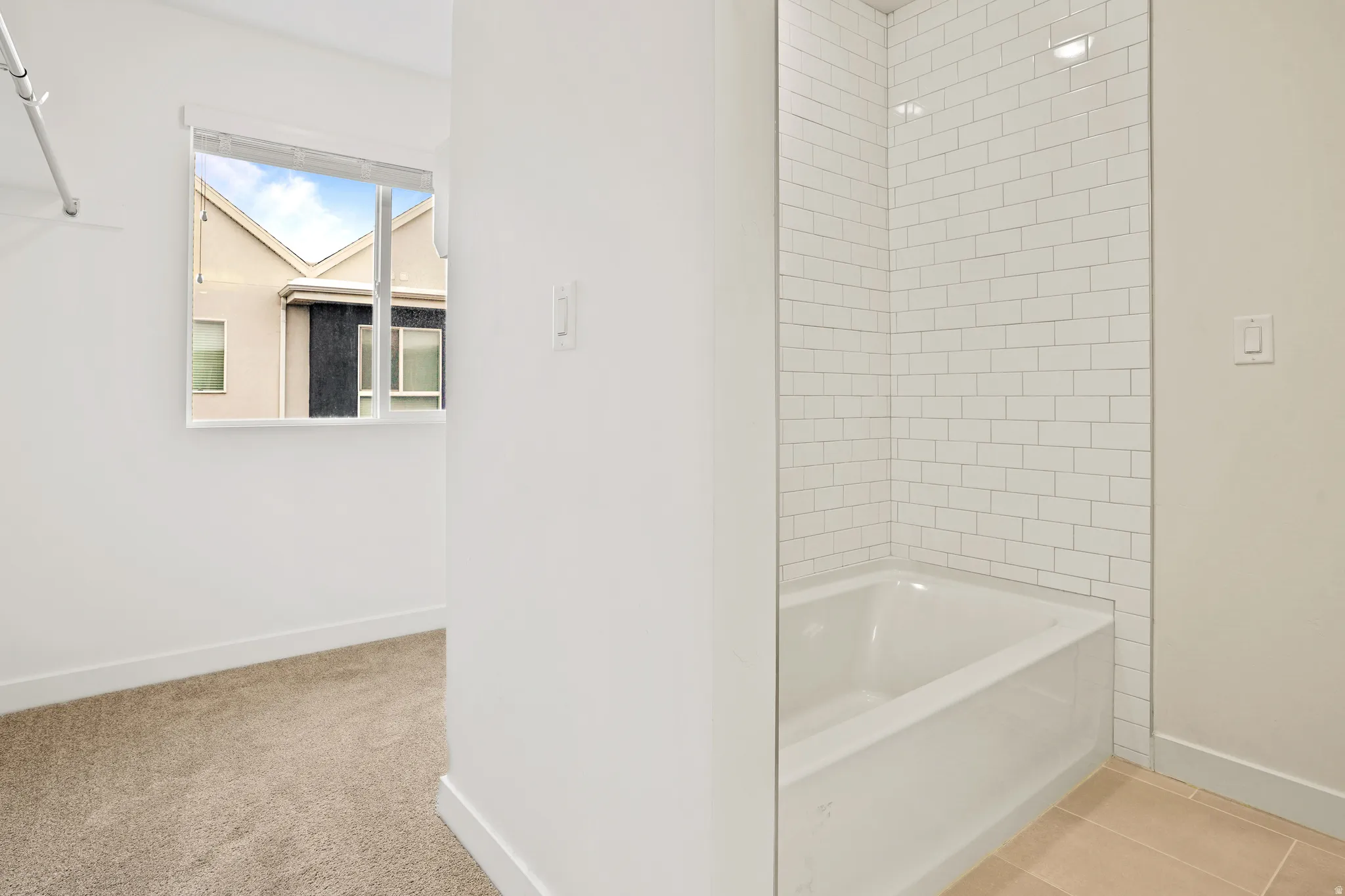 White subway tile shower surround with an integrated bathtub