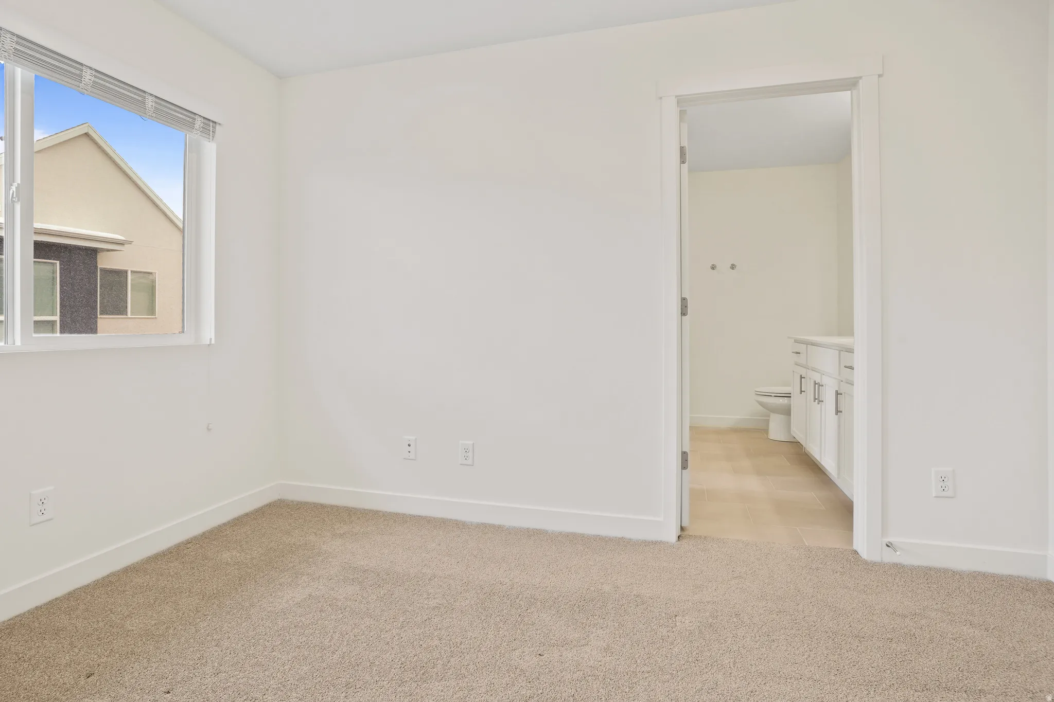 Light beige carpeting with white baseboards