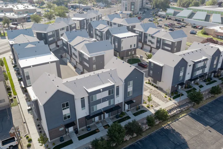 Contemporary townhome development featuring multi-level units with attached garages