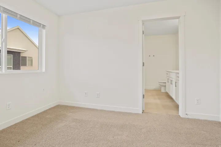 Light beige carpeting with white baseboards