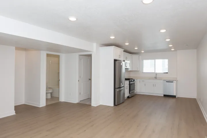 Open-concept living space featuring wood-finish flooring and recessed lighting