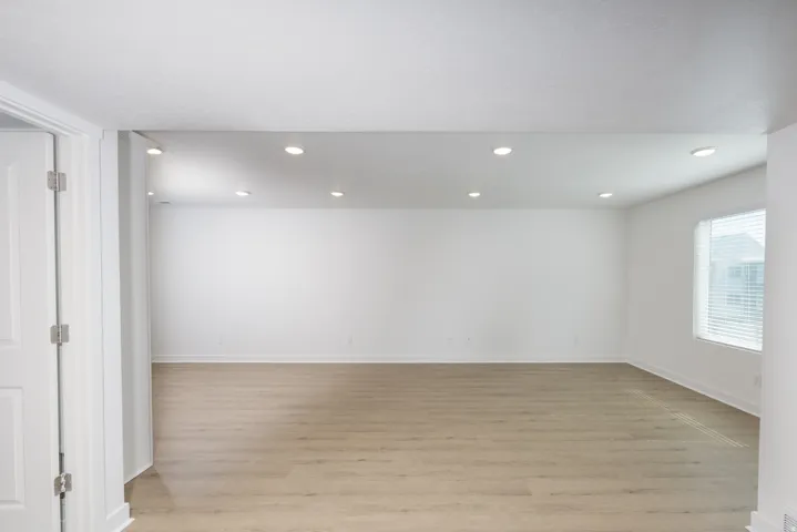 Spacious interior with neutral white walls and wood-finish flooring