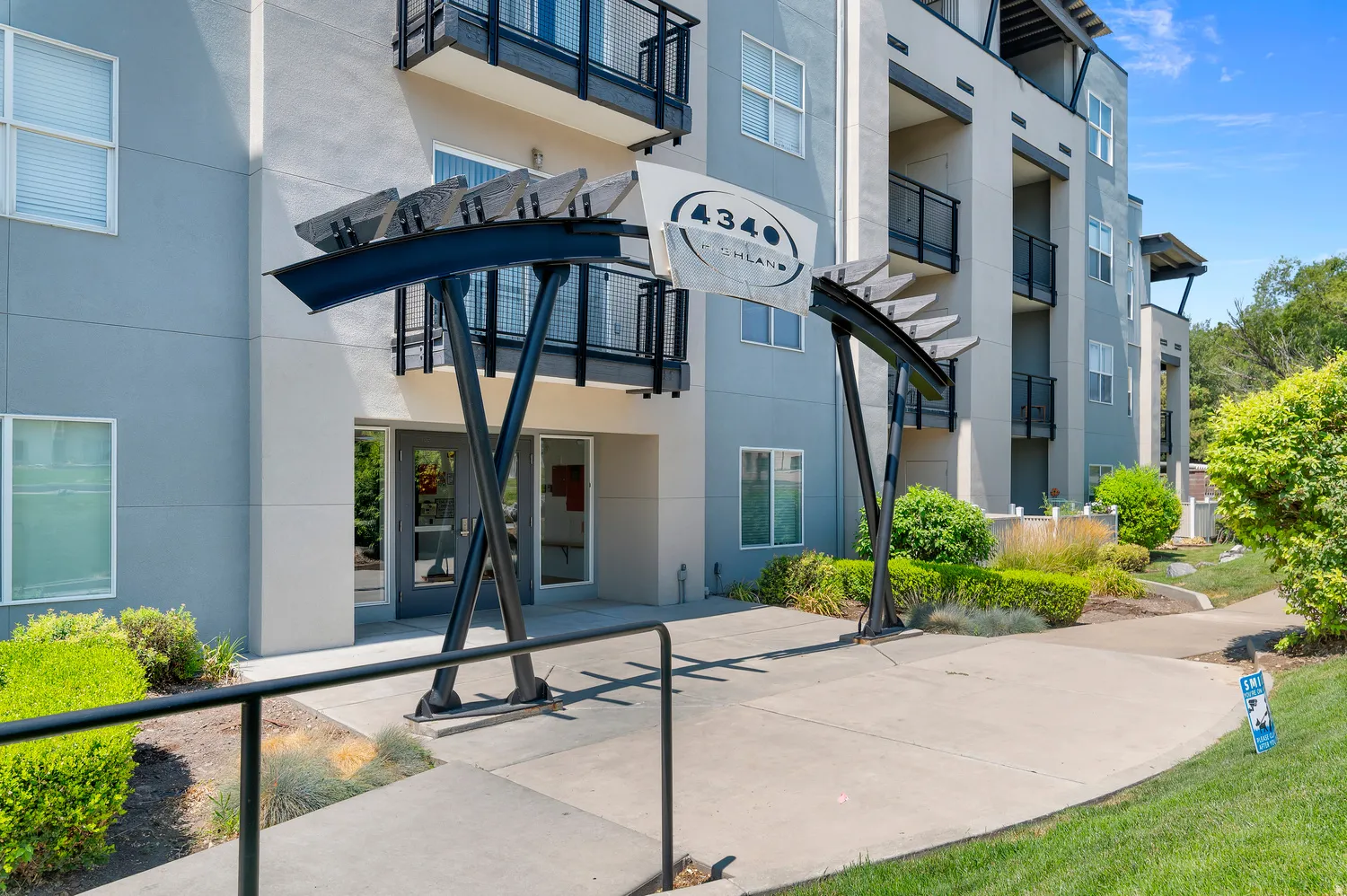 Modern building entrance with contemporary architectural detailing and integrated landscaping