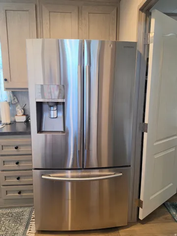 Stainless steel French door refrigerator with bottom freezer and external ice/water dispenser