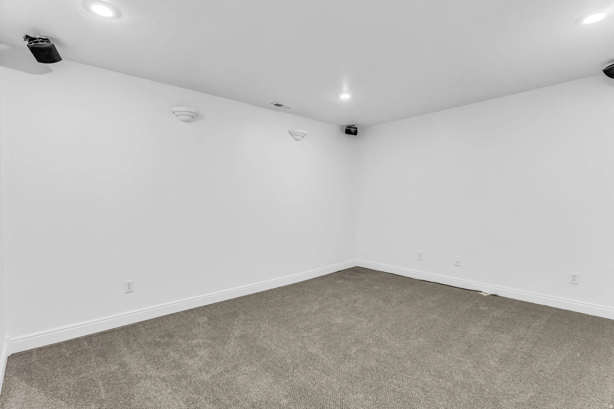 Recessed ceiling lighting, wall-mounted speakers, and new carpeting