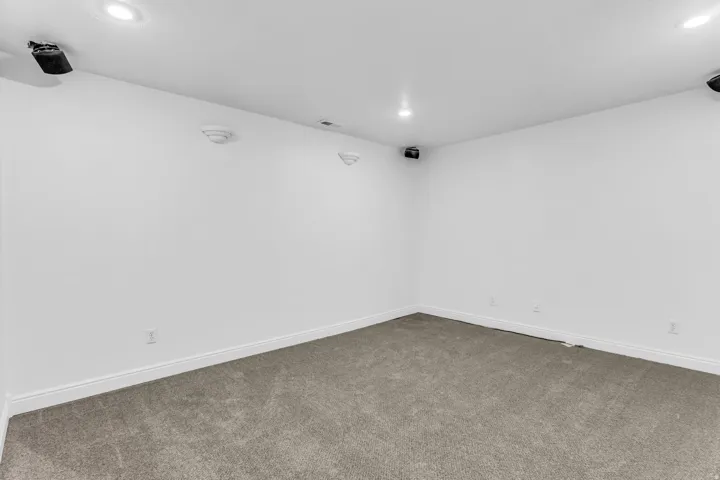 Recessed ceiling lighting, wall-mounted speakers, and new carpeting