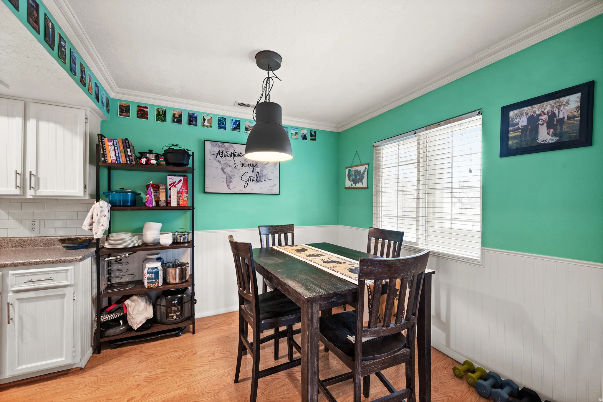 Dining area featuring wood-finish flooring and a contemporary pendant light fixture