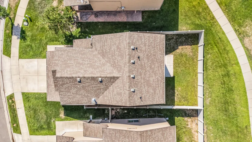 Aerial view showcasing a meticulously designed residential property with a multi-level architectural layout