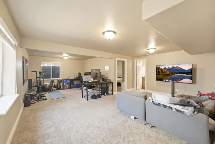 Spacious bonus room featuring recessed ceiling lighting, neutral carpet flooring, and multiple windows providing natural light