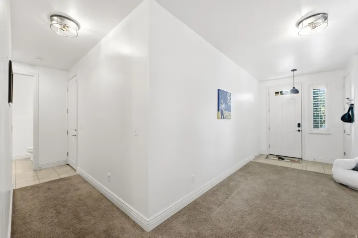 Bright, open floor plan with soaring vaulted ceilings and abundant natural light from recessed fixtures