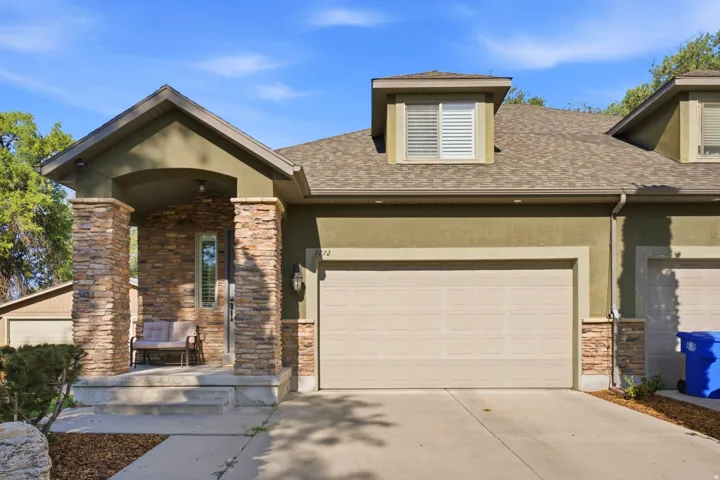 Welcoming brick and stone exterior with arched entryway and covered porch