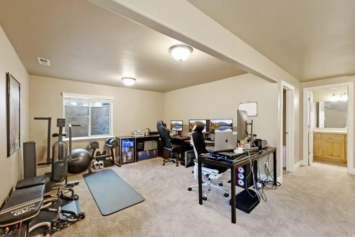 Carpeted room with recessed lighting and a window